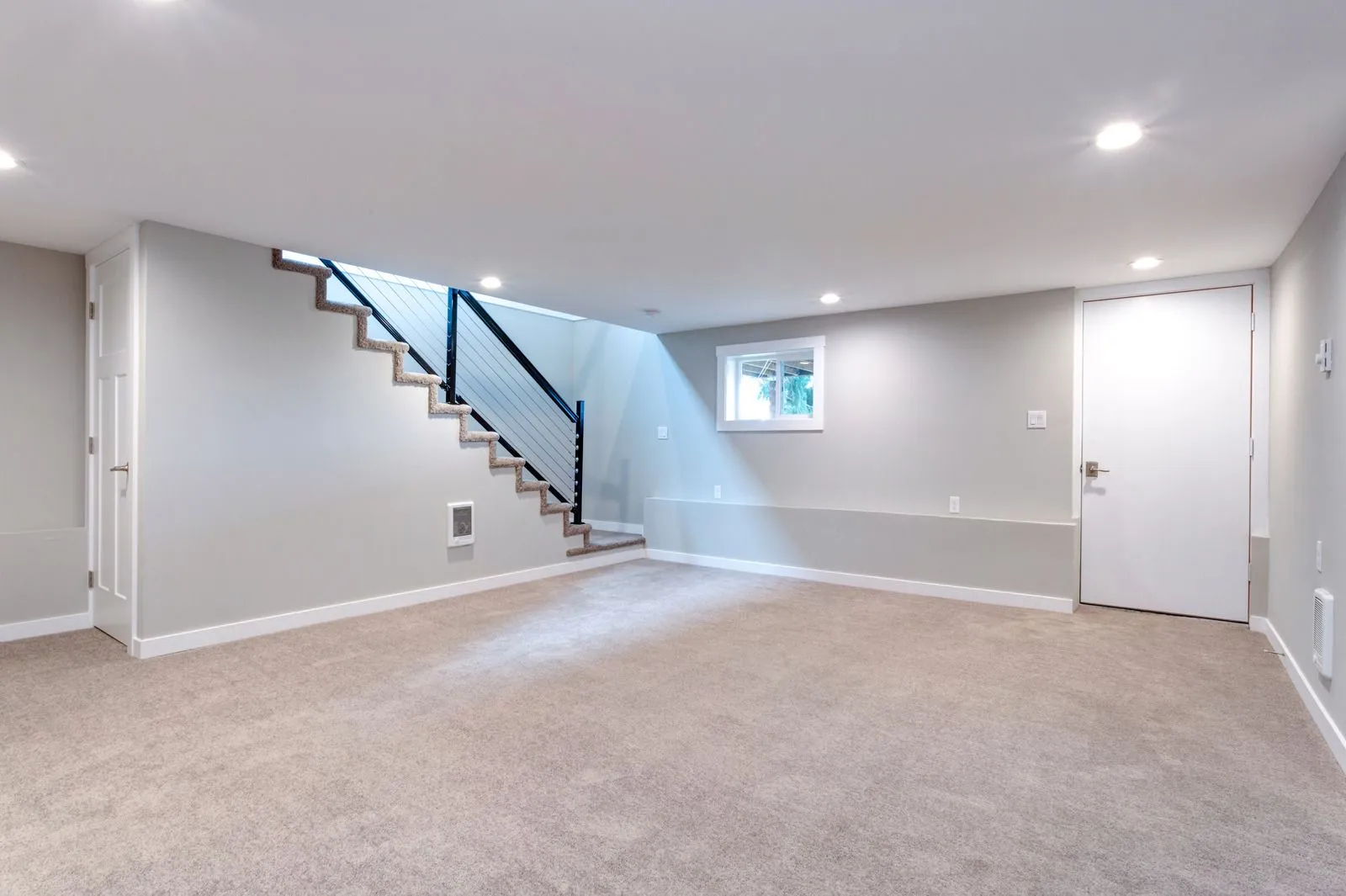"Finished basement with soft beige carpet and modern staircase in Centennial, CO"
