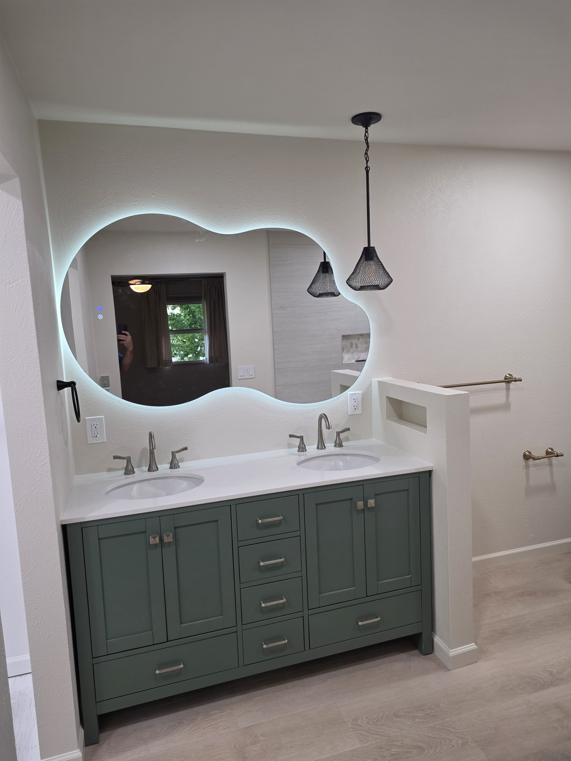 Tiled shower bench and niche with pebble mosaic detail in a Littleton, CO bathroom