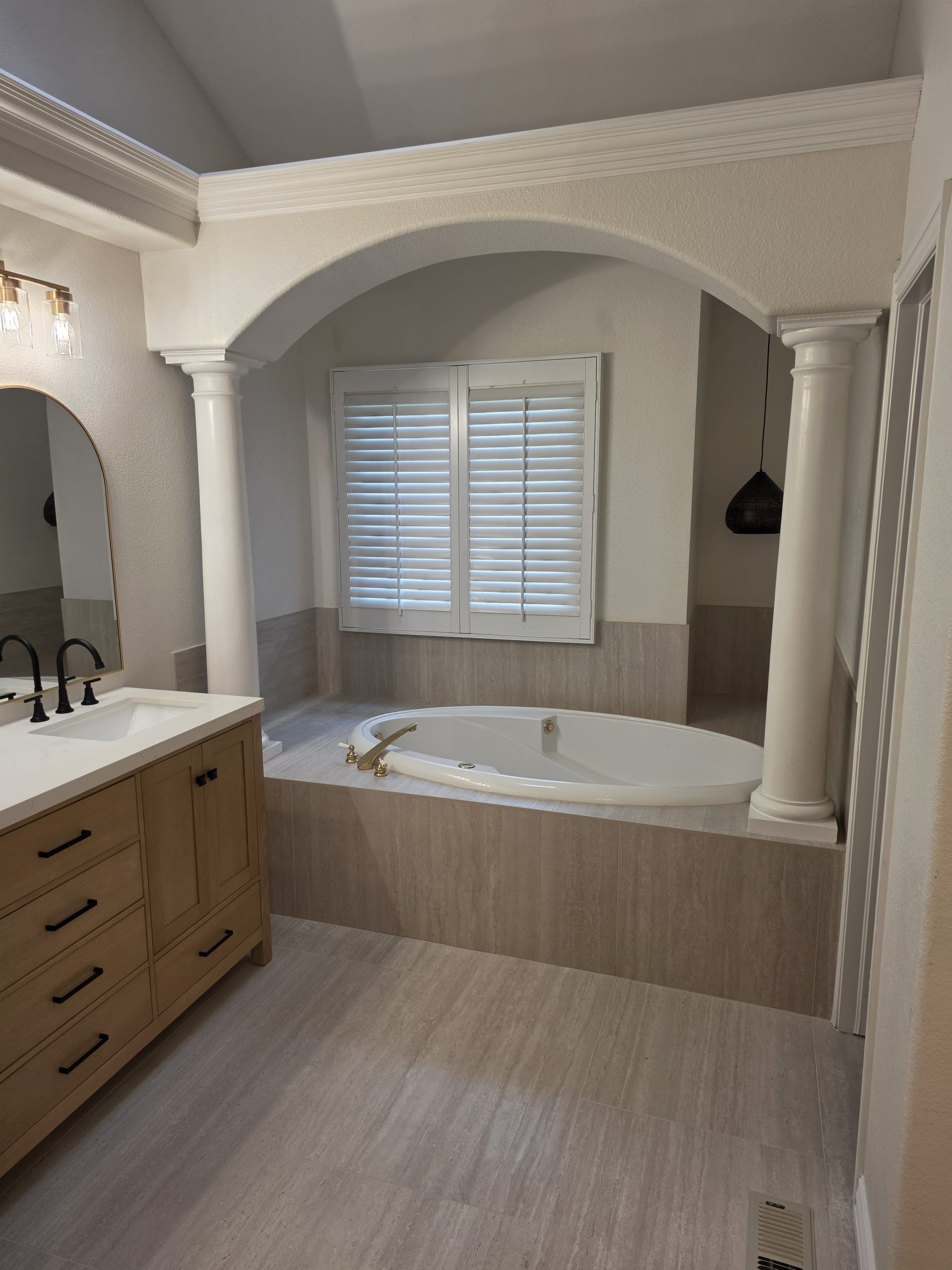 Corner soaking tub set into a tiled alcove in a Highlands Ranch, CO master bathroom