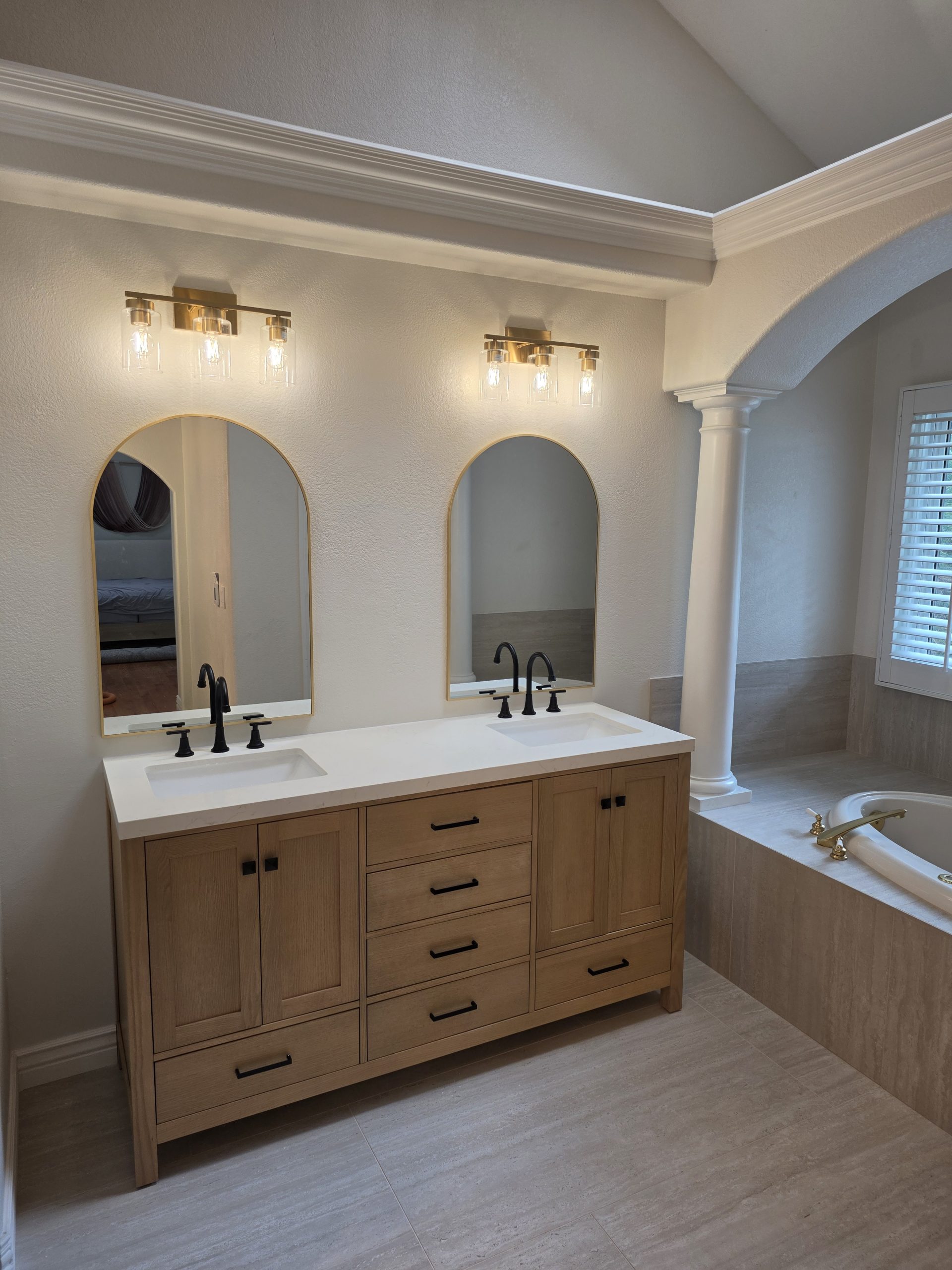 White oak vanity cabinetry with matte black hardware in a Highlands Ranch, CO bathroom remodel