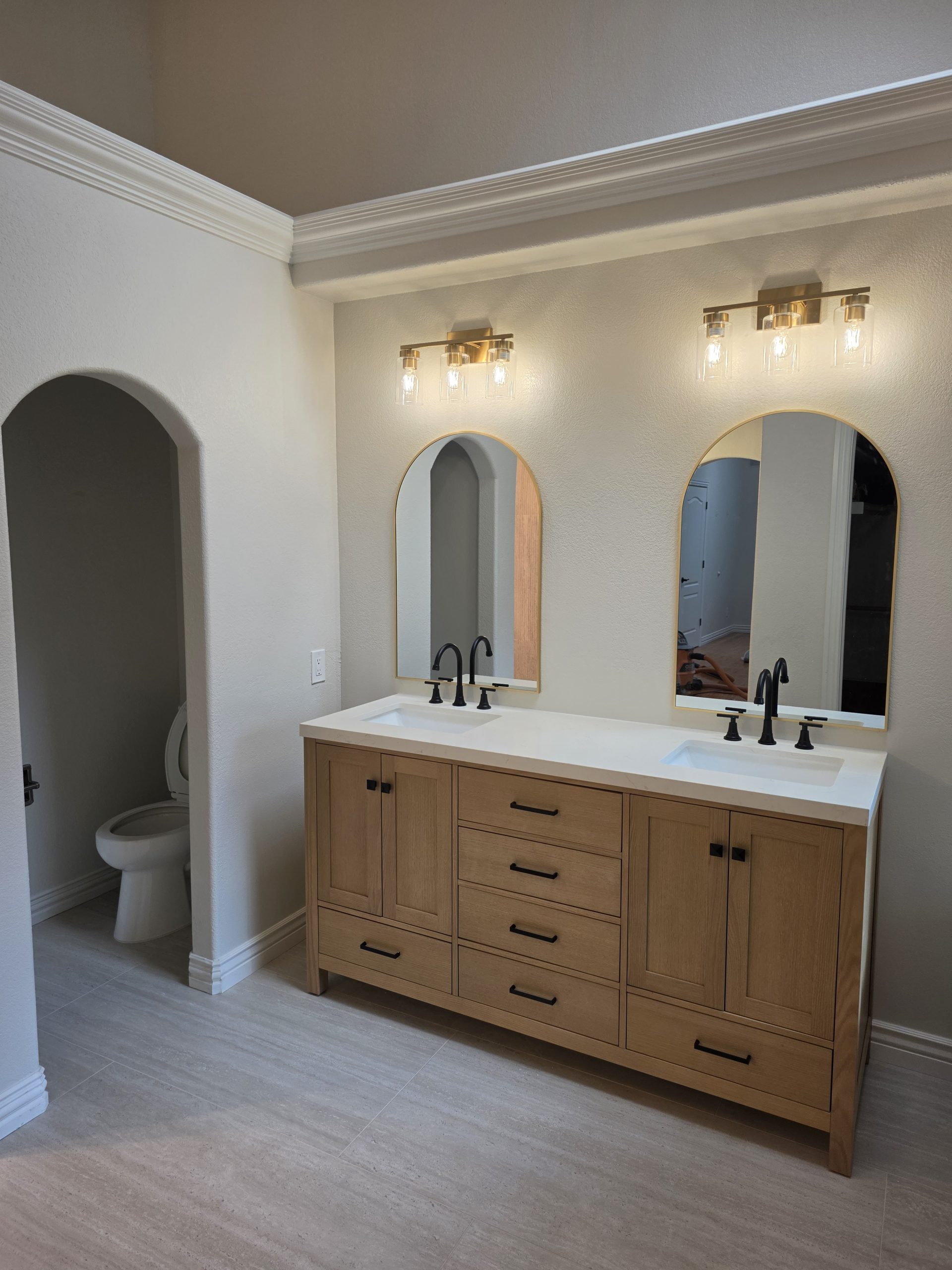 Finished master bathroom with oak vanity and tiled walls in Highlands Ranch, CO