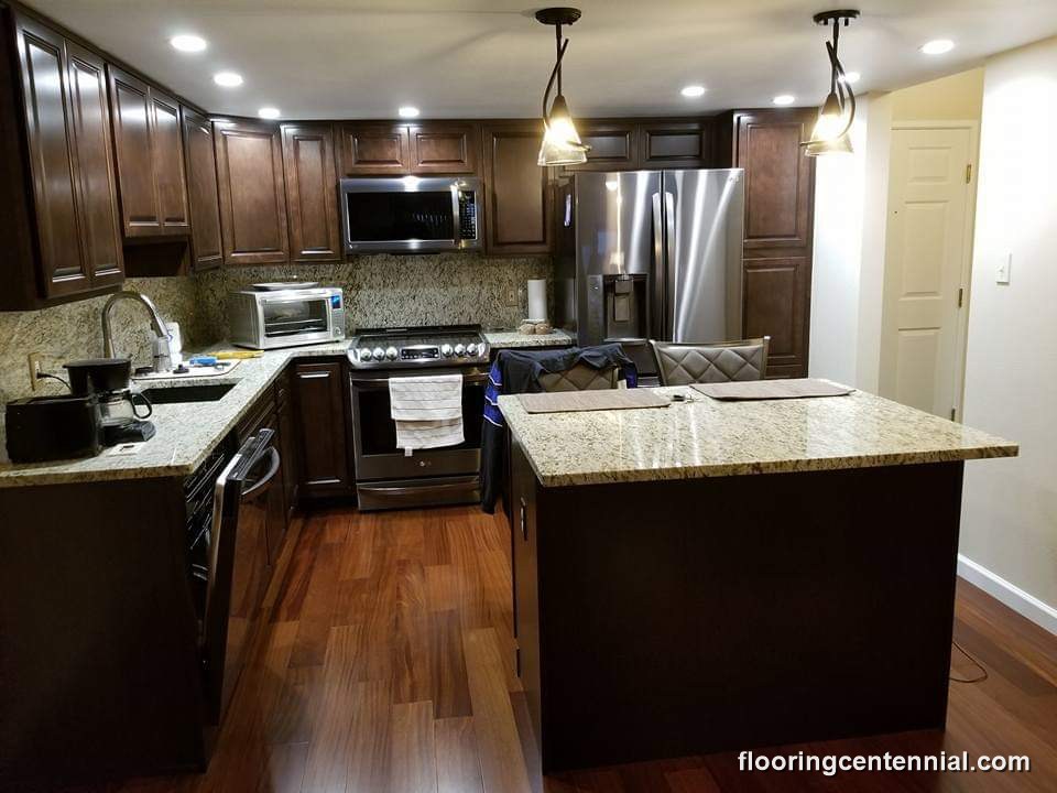 Kitchen remodel with dark cabinetry, granite counters, and hardwood flooring