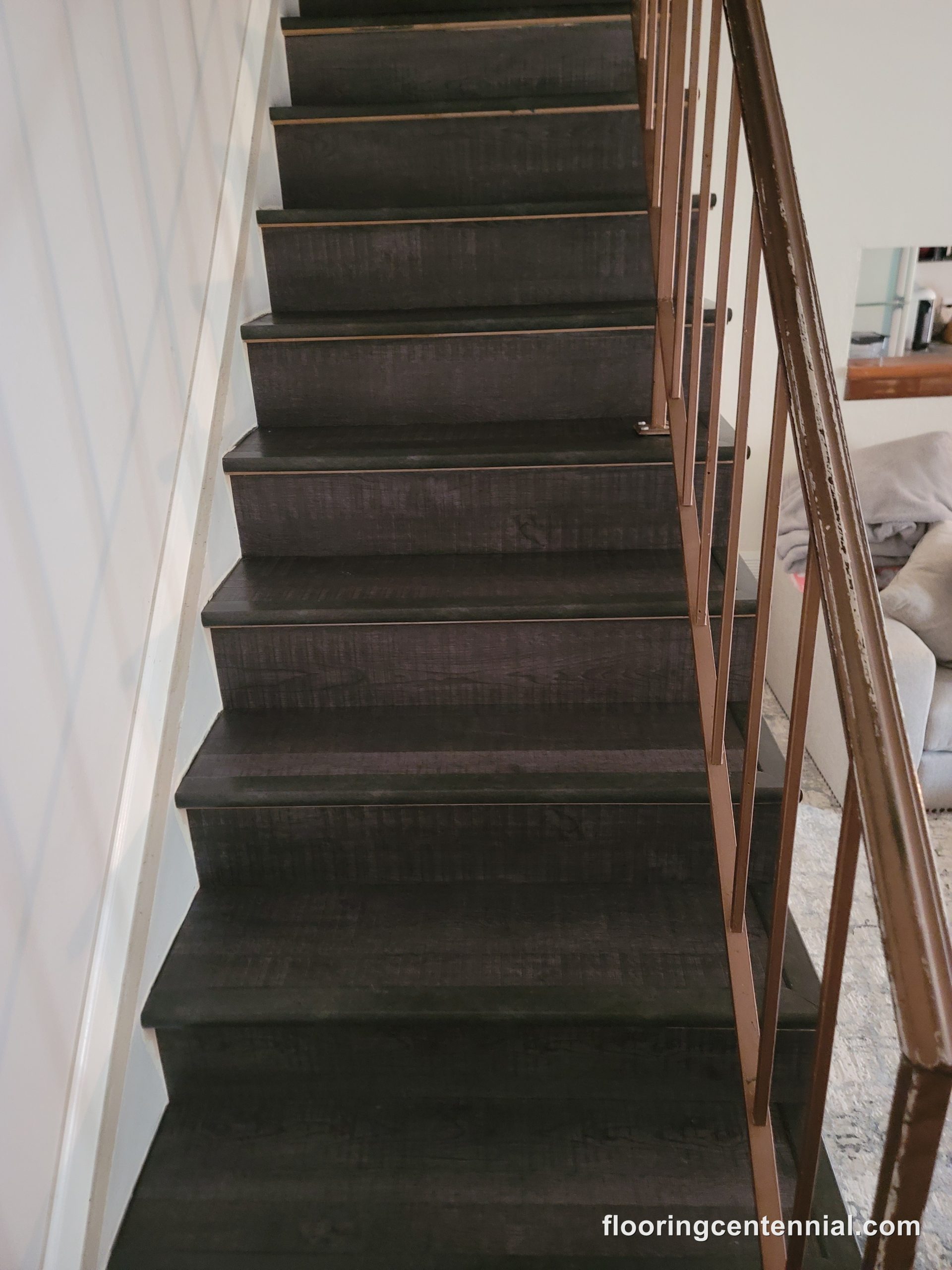 Dark ebony stained staircase with modern copper-toned railing