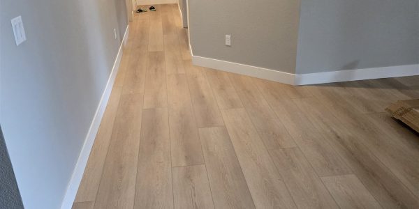 Bright hallway with light wood-look vinyl plank flooring