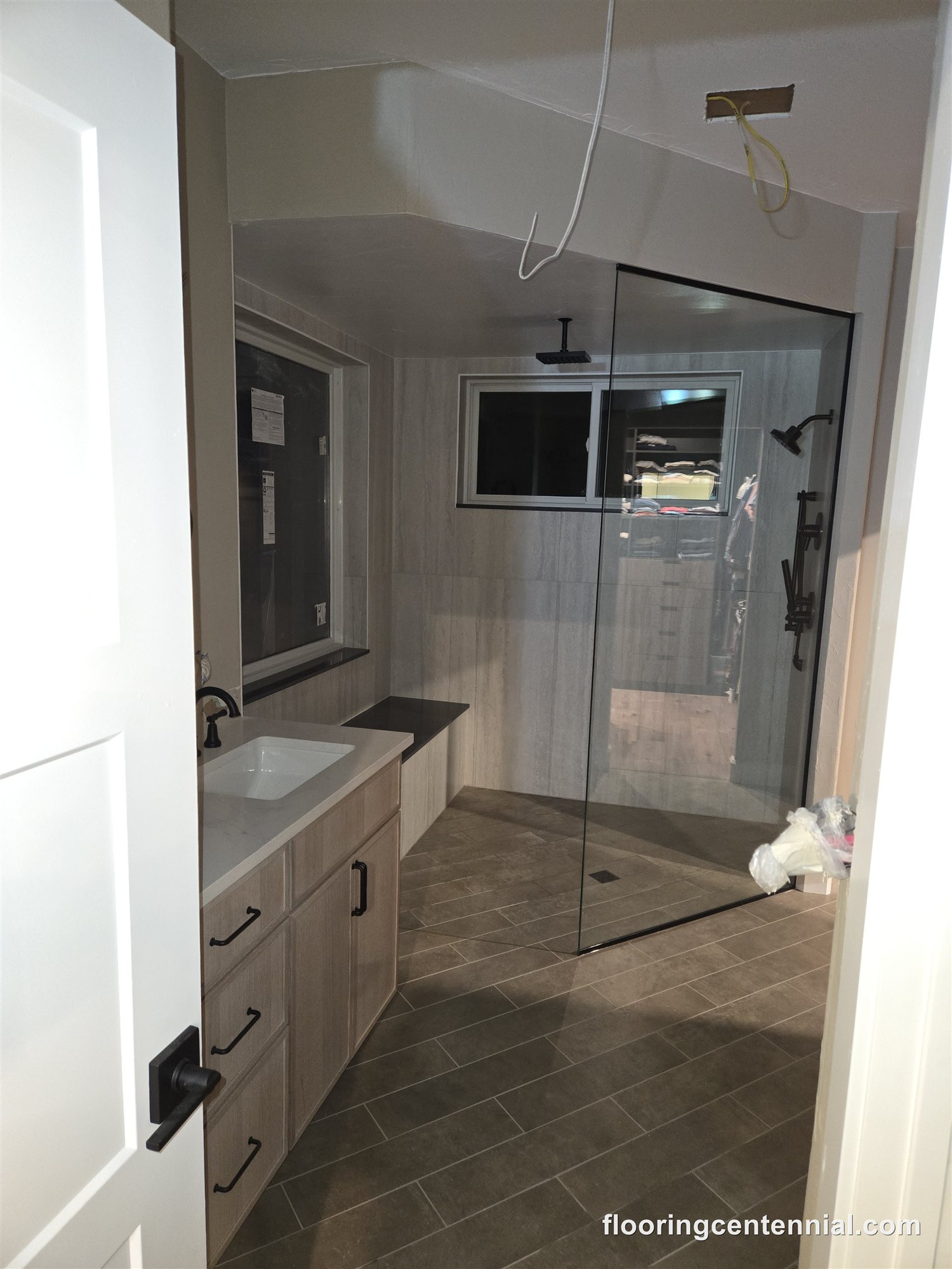 Walk-in tile shower with glass enclosure in a Morrison master bathroom