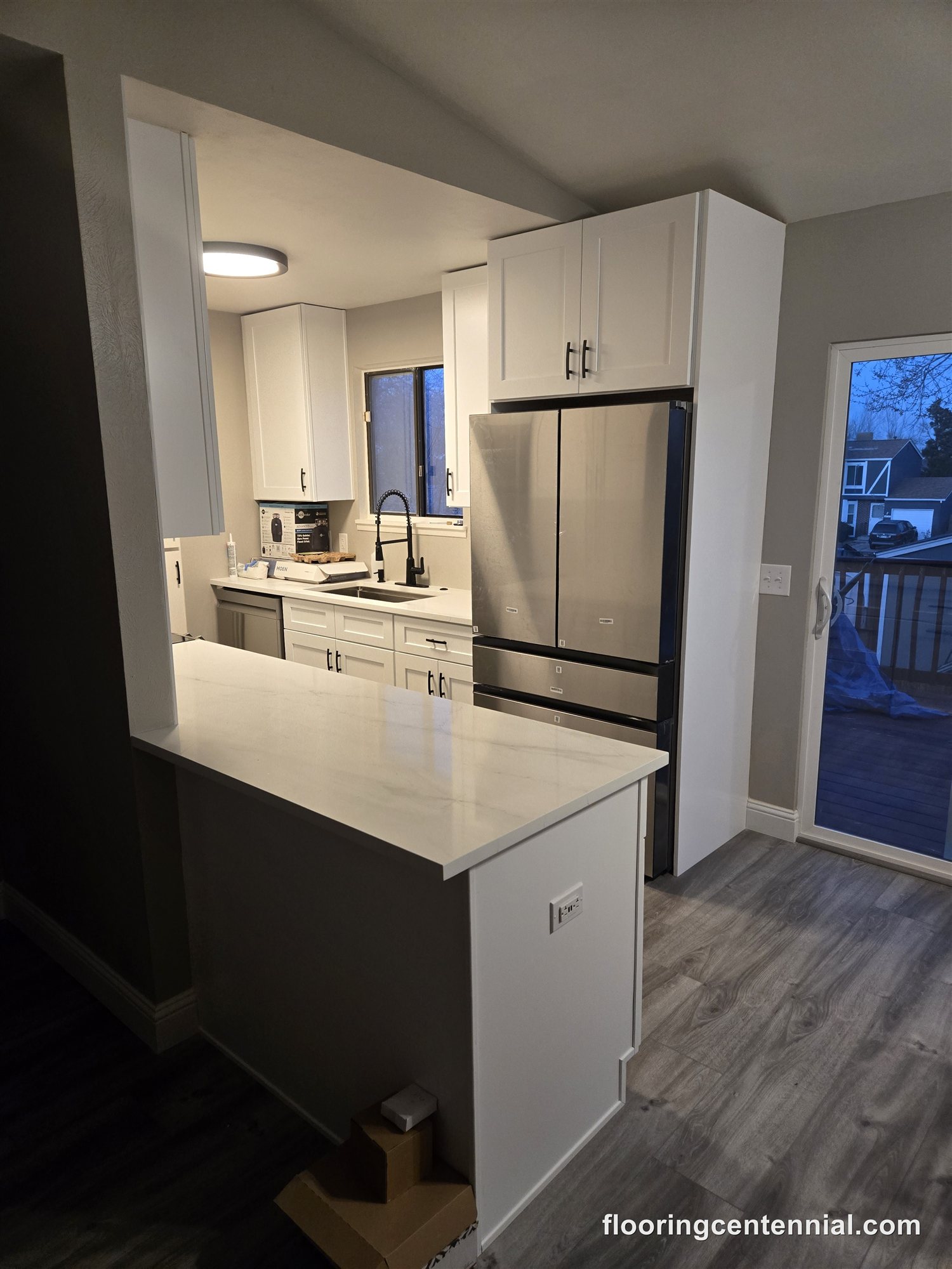 Kitchen with new white cabinets and LVP flooring, Aurora CO