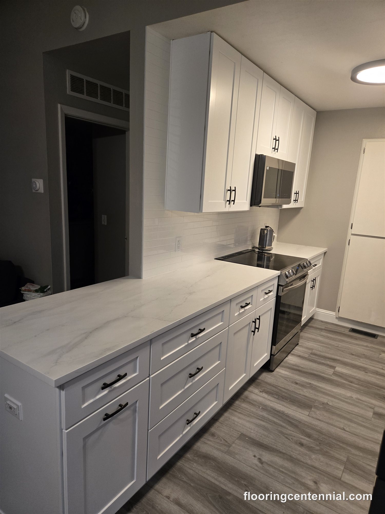 New kitchen cabinets and island with luxury vinyl plank flooring, Aurora CO