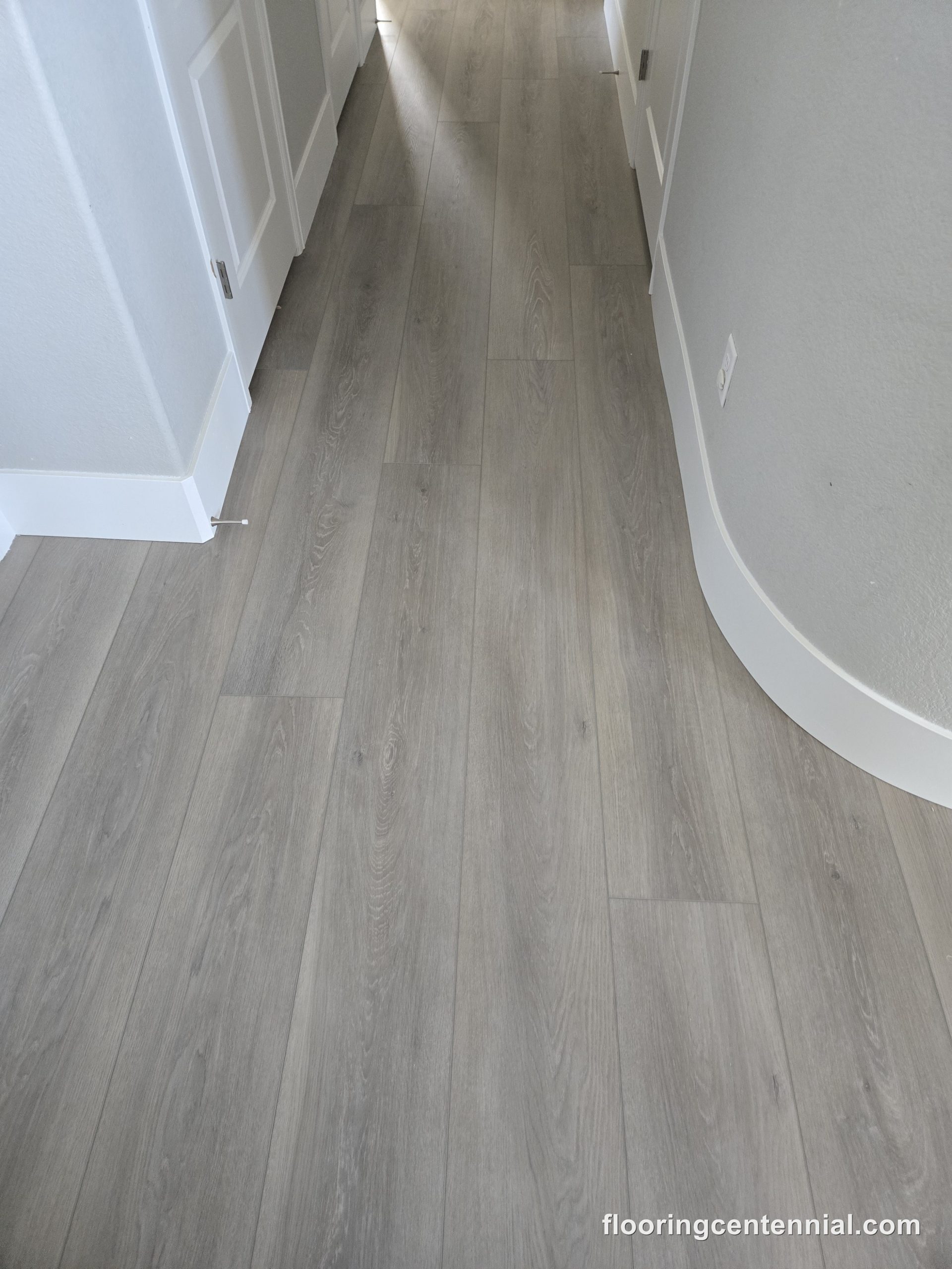 Gray wood-look luxury vinyl plank with matching trim, Aurora CO