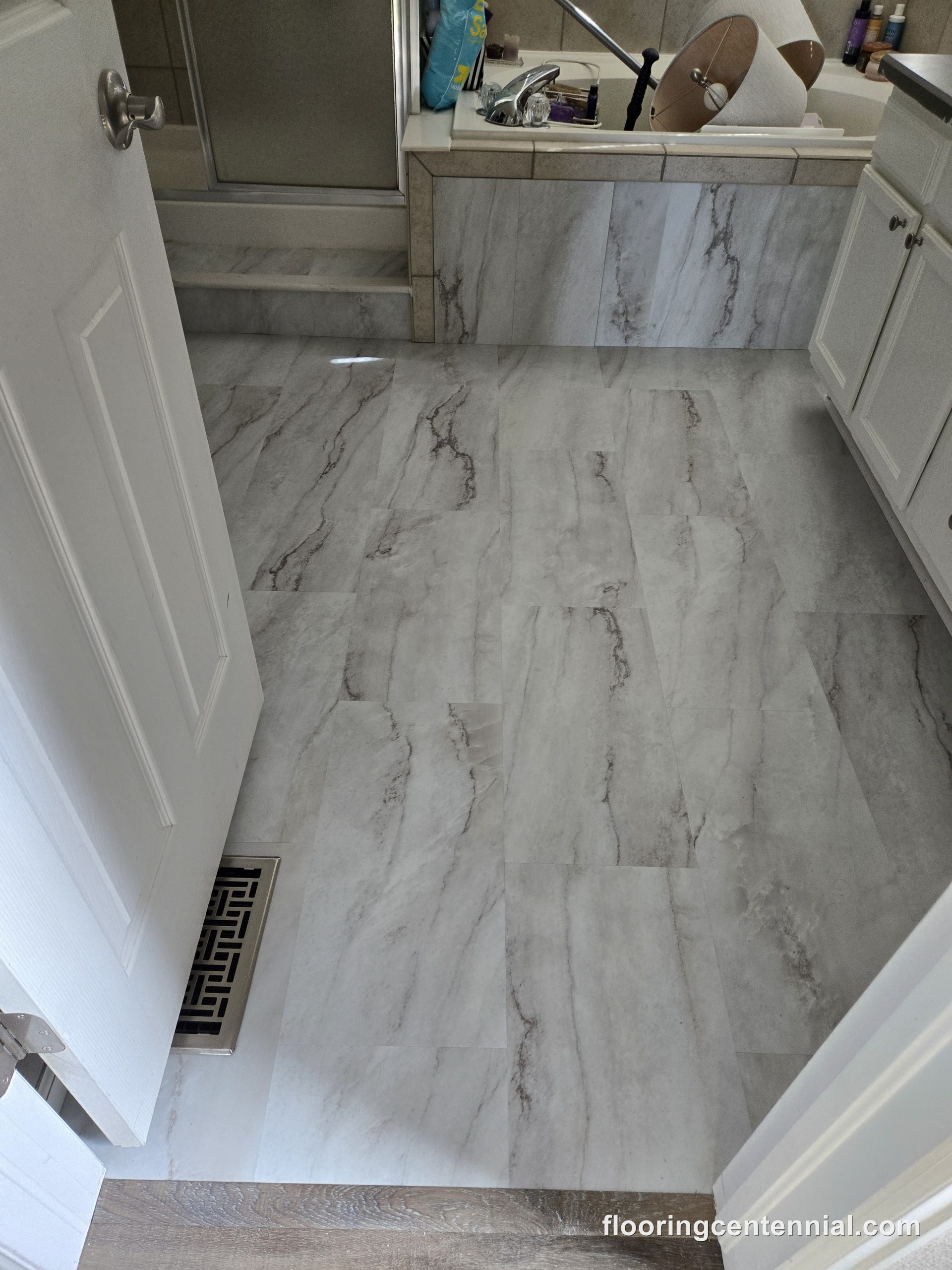 Bathroom shower wall with large-format marble-look tile