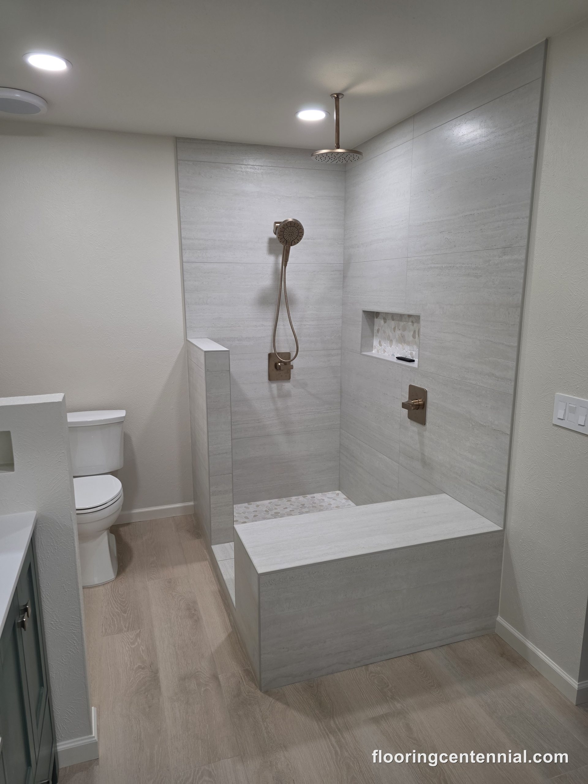 Walk-in shower with built-in tile bench and storage niche
