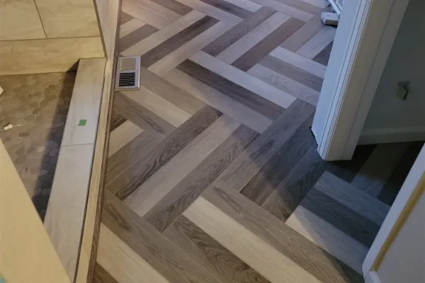 Herringbone wood-look tile flooring installed by Floor & More